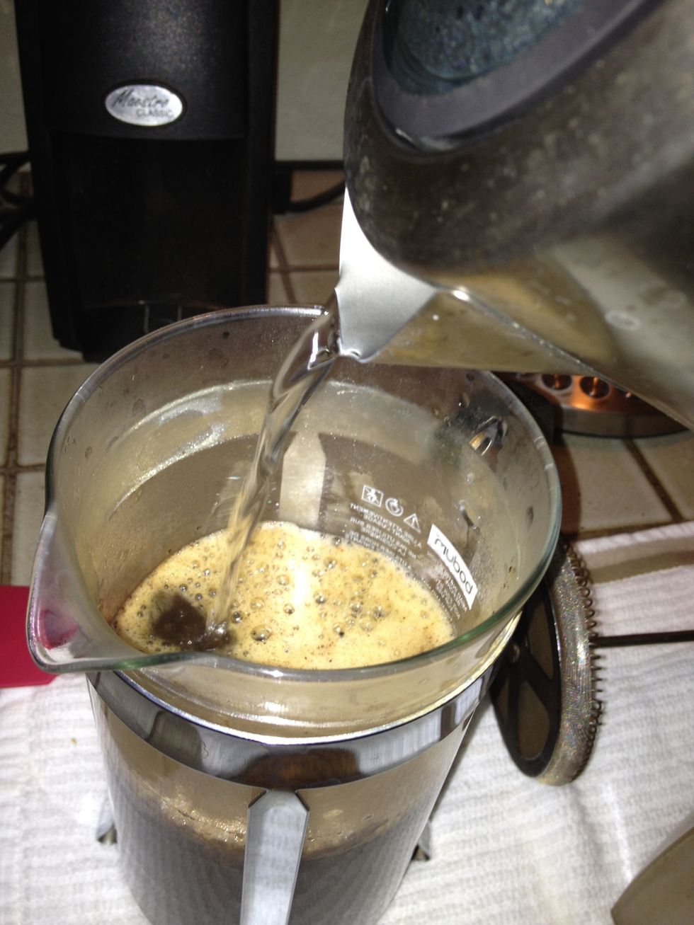 Fill the rest of the way with water. Put on the lid to help retain heat, but don't press yet.