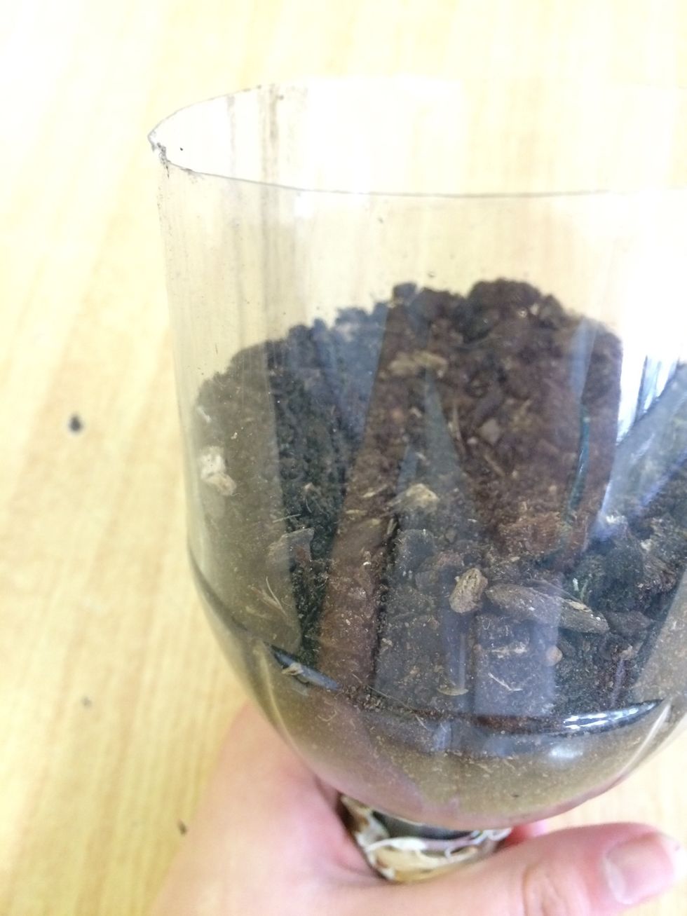 Fill the top with soil. Don't worry it won't fall through the material!