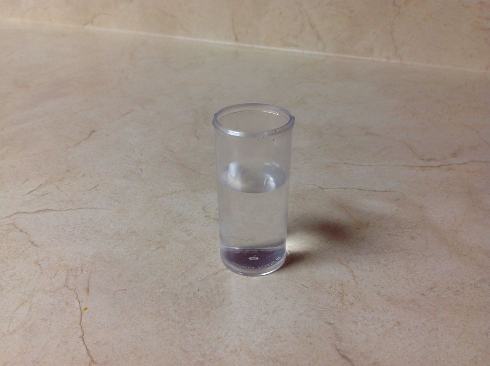 Fill the vial with 25 mL of room-temperature water. Let the vial stand for 1 minute undisturbed, so that the water stops moving.