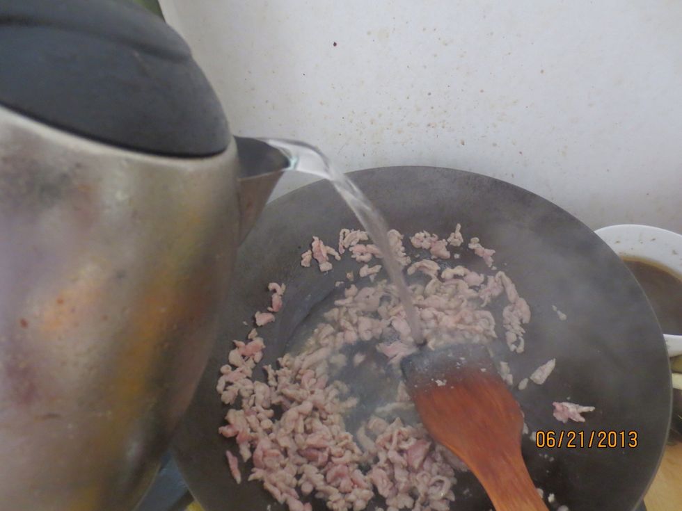 Fill the wok halfway with water...remember the more water you add the thinner your porridge will be and vice versa!