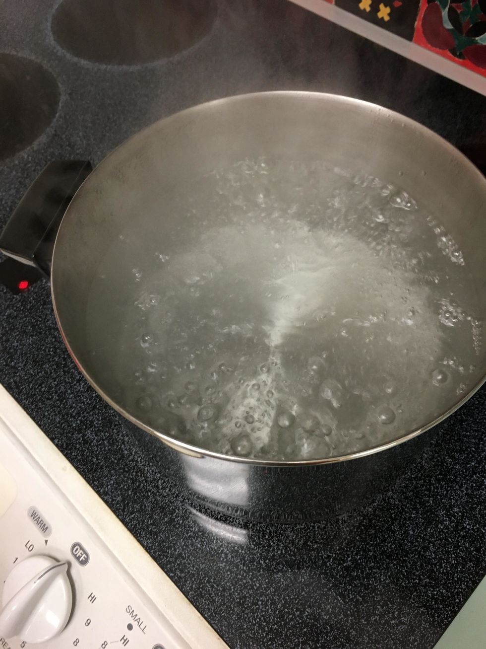 Fill up the pot with water approximately 1/2 full. Then turn on the burner. You want to bring your water to a rolling boil.
