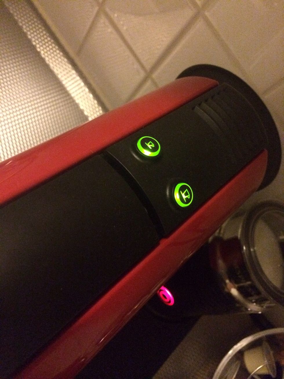 Fill up the watertank and turn the machine on by pressing one of the buttons on the top.