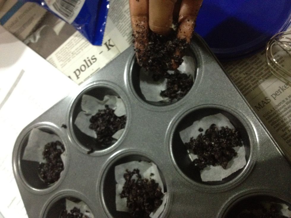 Fill up your muffin tray lined with parchment paper, or spray with non stick cooking spray, with your cookie base.