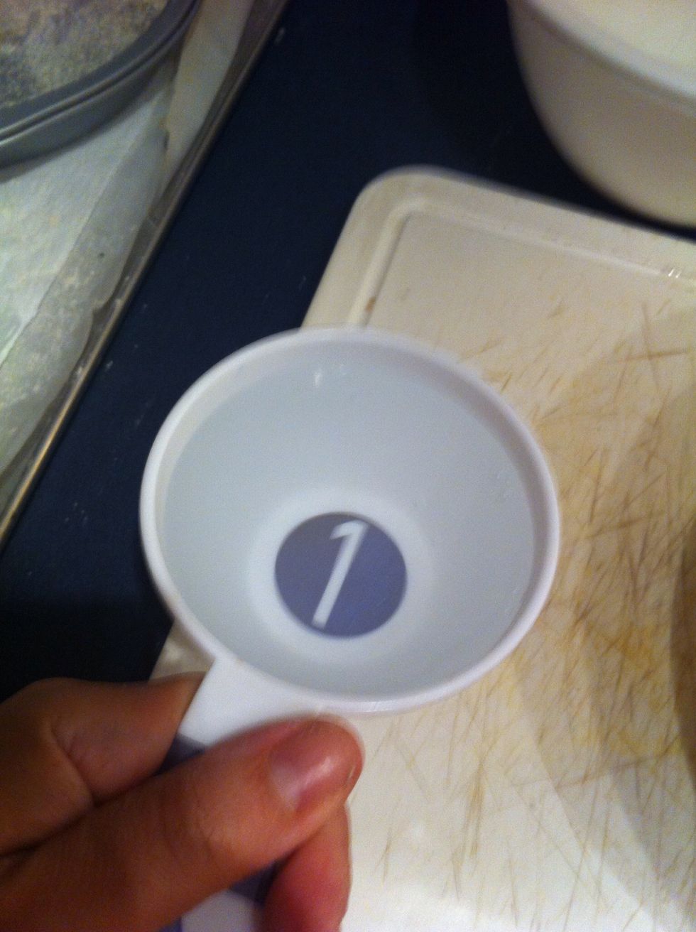 Fill water into a one cup measuring cup then pour in bowl with mix