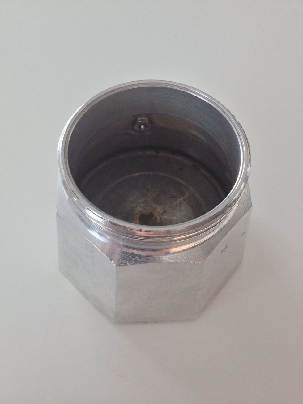 Fill with cold water up to the hole (the pressure release valve).