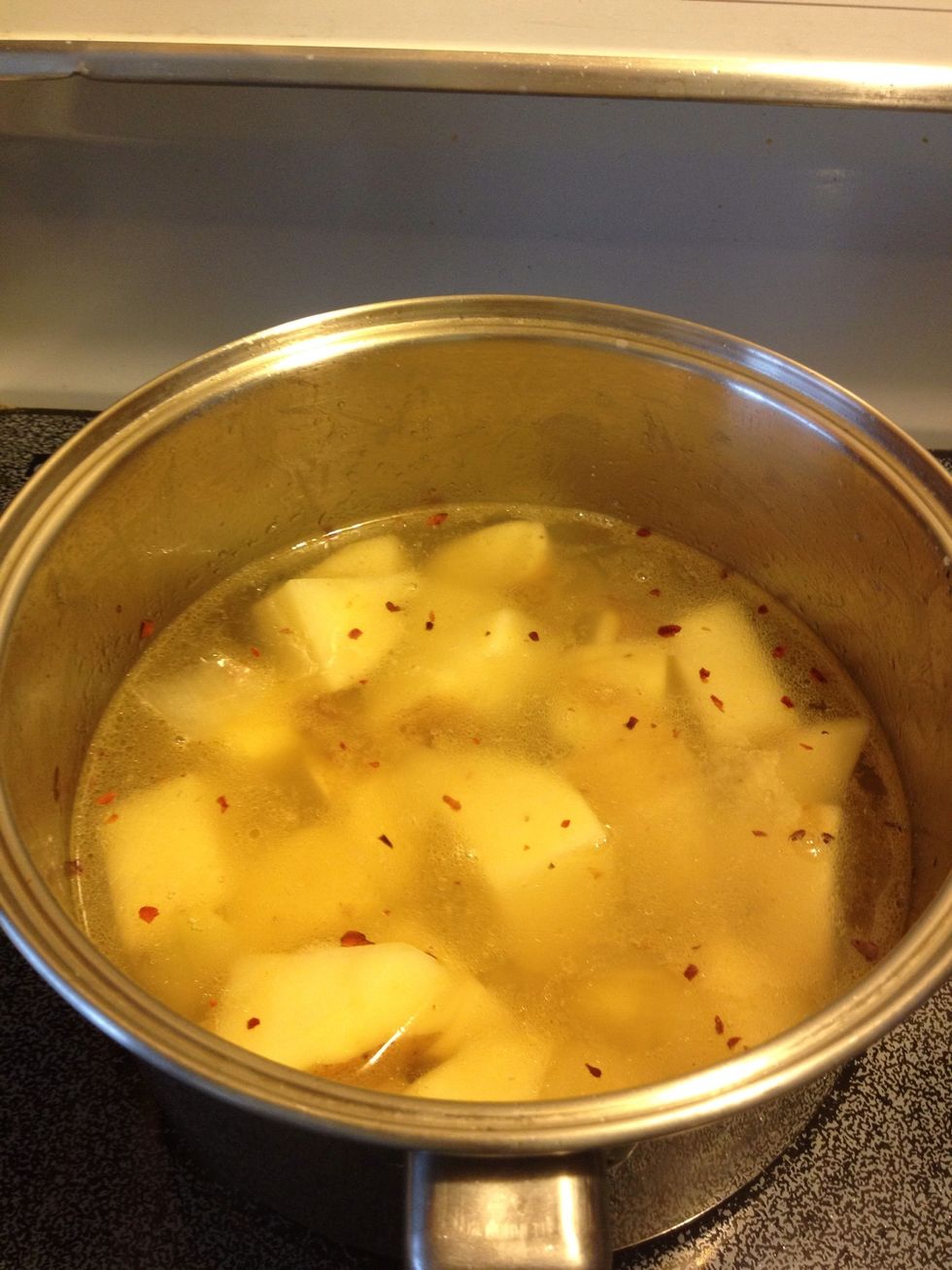 Fill with water until potatoes are just about submerged. Cover and bring to a boil..