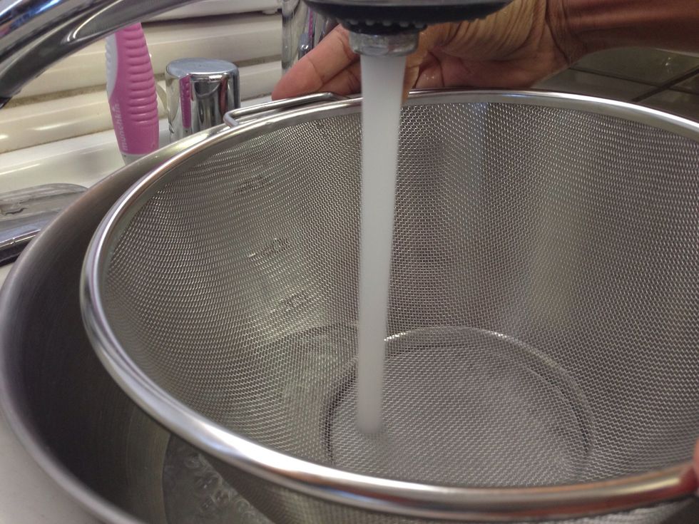 Fill your bowl with cold water and if strainer fits inside as in picture, go ahead and have strainer in it  while filling with water.