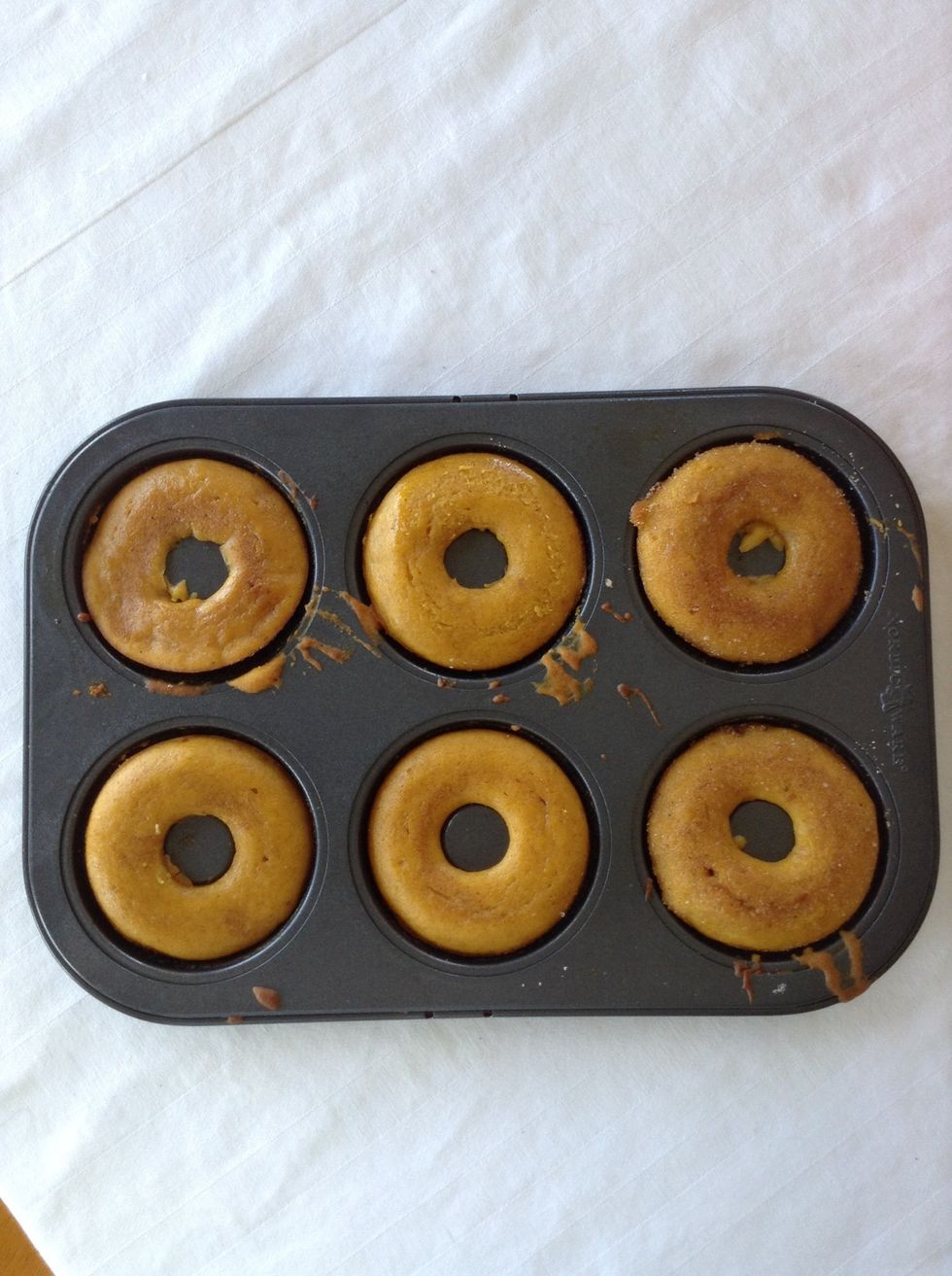 Fill your doughnut pans full and bake at 350 degrees Fahrenheit for 15 minutes. They are done when you poke them a toothpick and they come out clean!