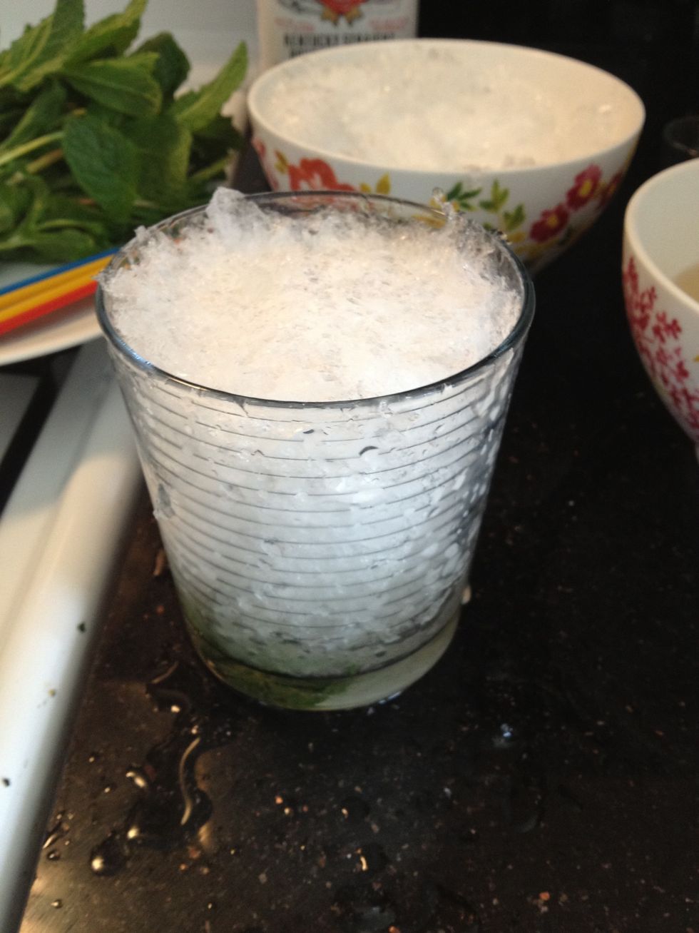 Fill your glass with crushed ice. To crush my ice, I use a snow cone maker. The ice comes out a little too fine, but it works. In a pinch you can place ice cubes in a towel and break with a hammer.