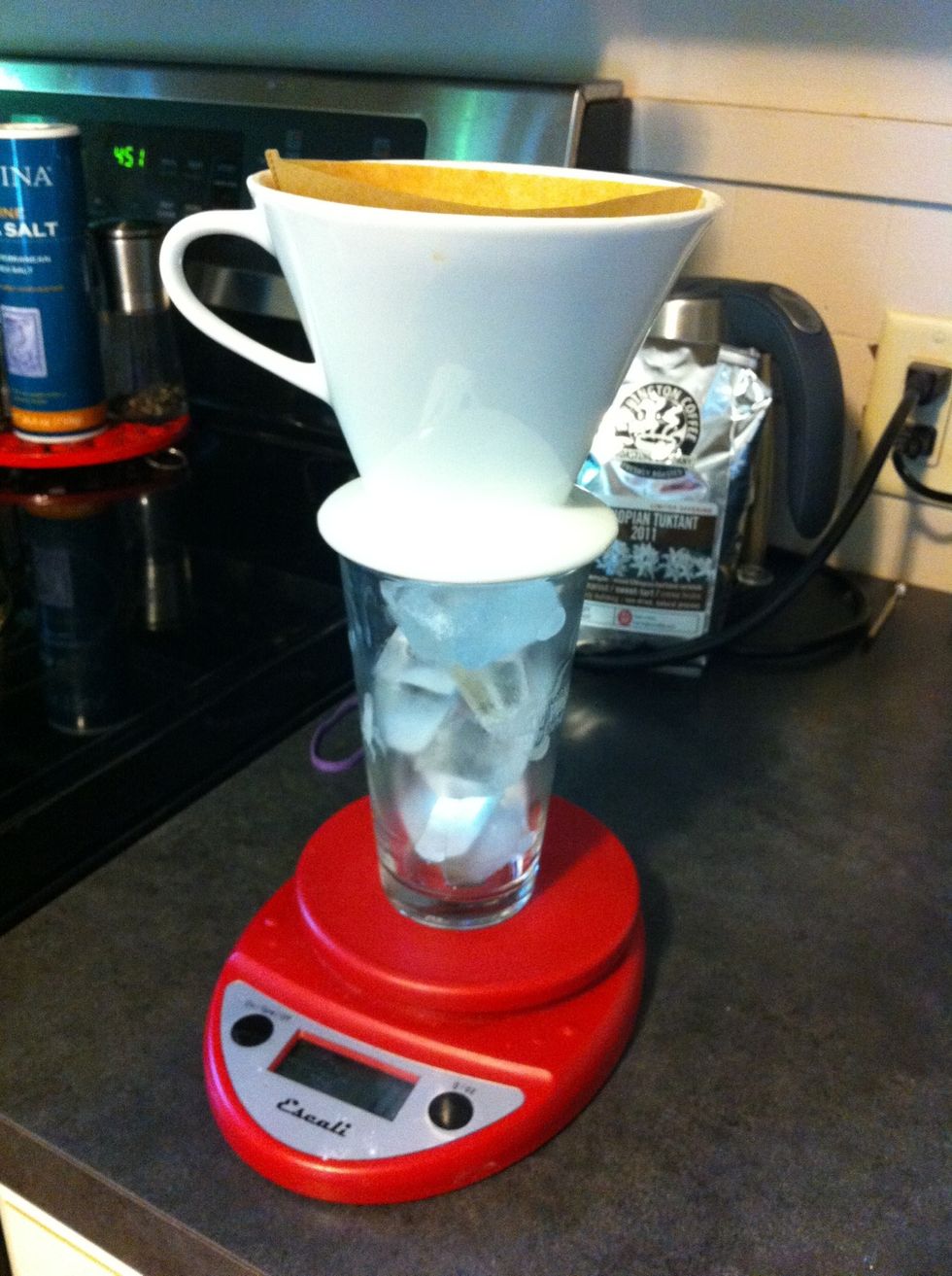Fill your glass with ice up to the top. Assemble as shown. Tare your scale to zero. As we pour, we are going to measure the amount of water being added with the scale to 175 grams.
