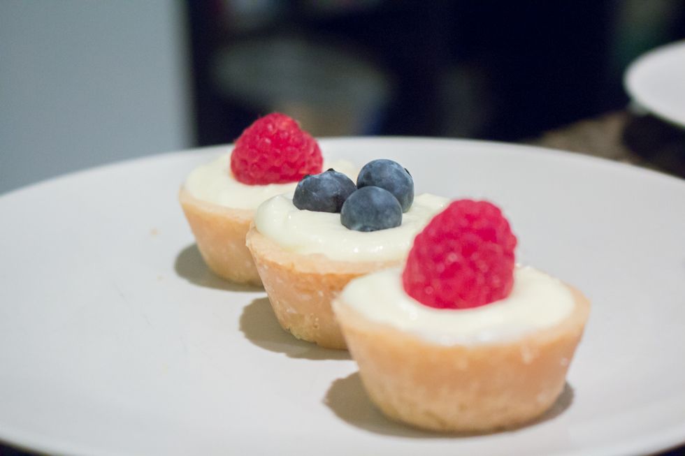 Fill your mini tartlets with the lemon curd mousse and top with a field berry.