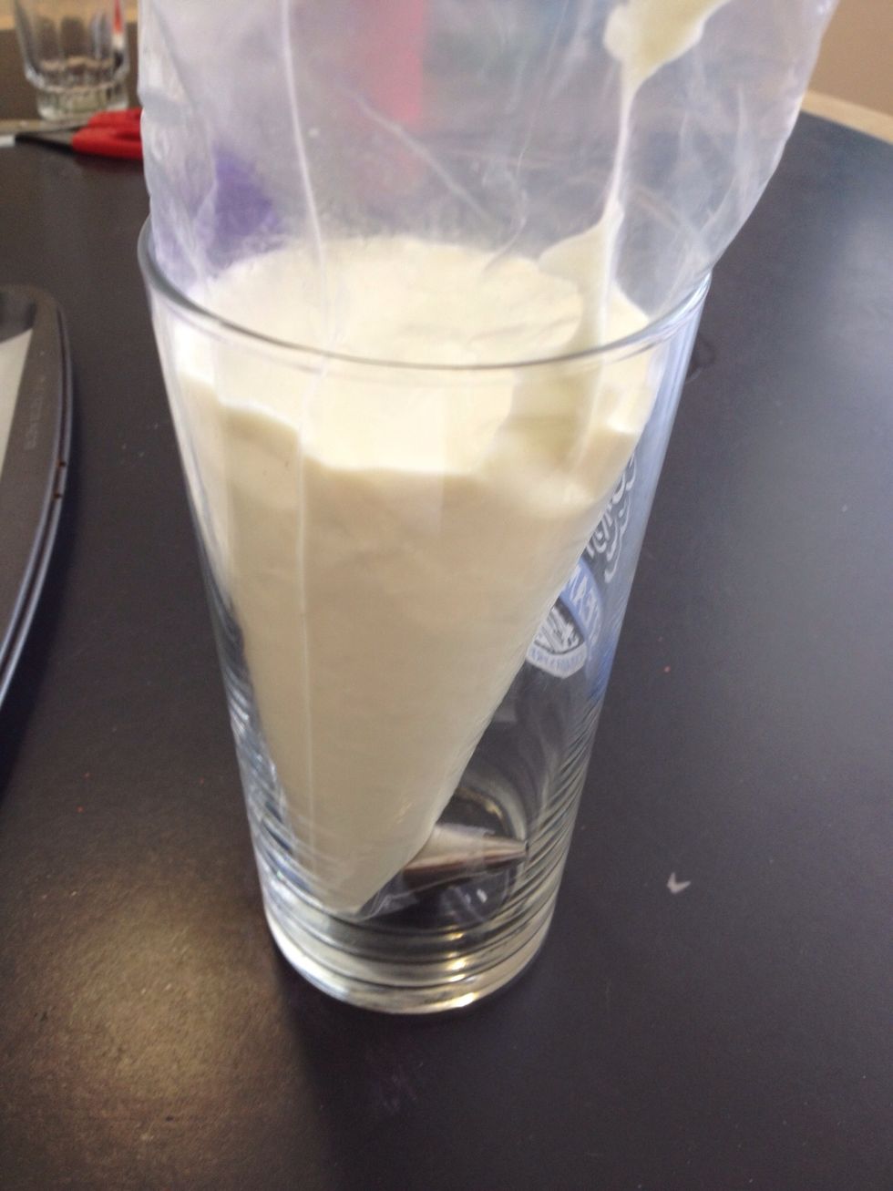 Fill your piping bag fitted with the tip with the melted chocolate. Tip: use a cup to hold the bag while you fill it. If you don't have a piping bag and tip, cut the corner off a ziplock bag.