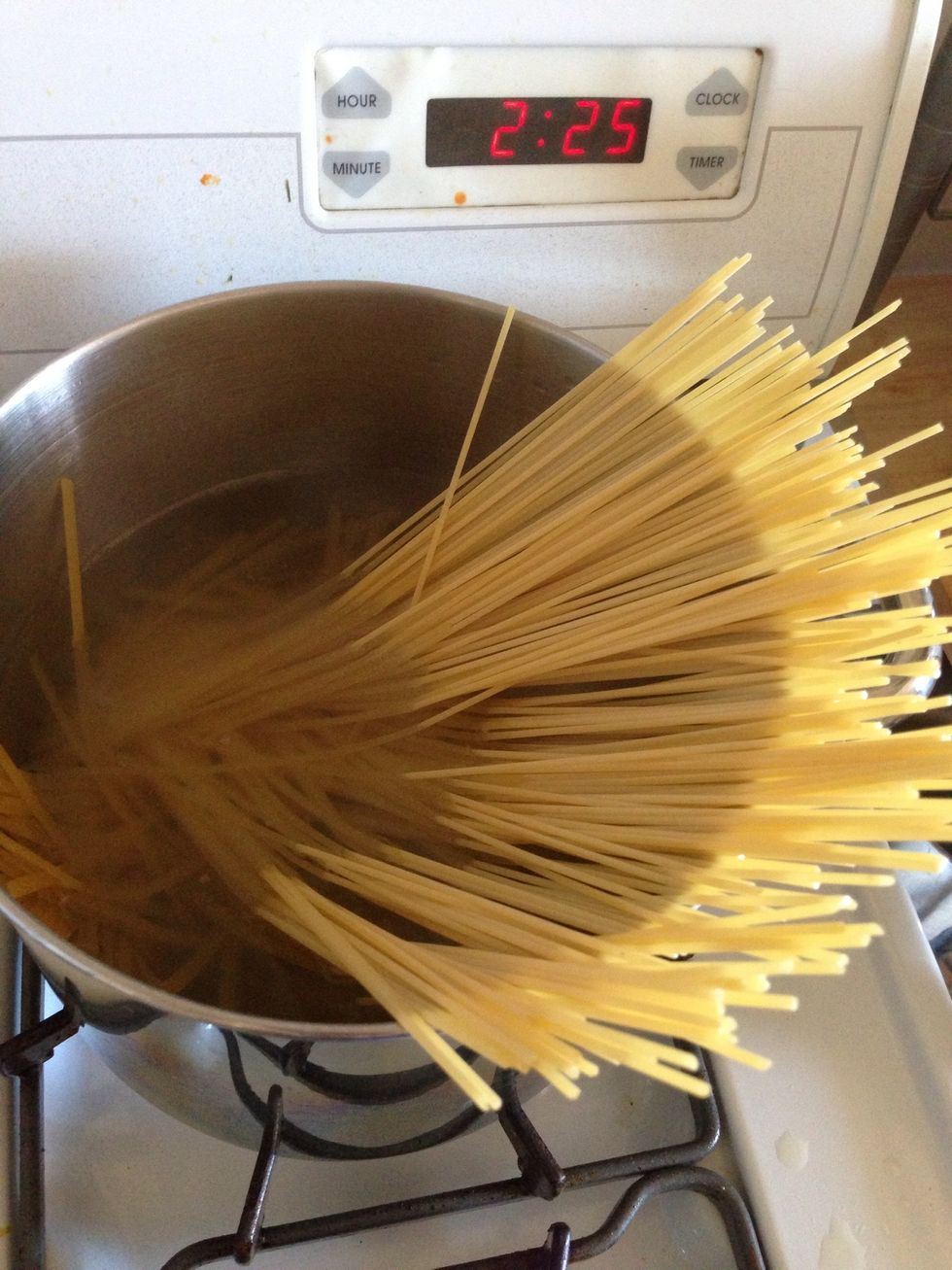 Fill your pot about half way with water and add about 2 tbs of salt. Boil. Once the water is boiling add the fettuccine pasta. I use about 2/3 of the package.