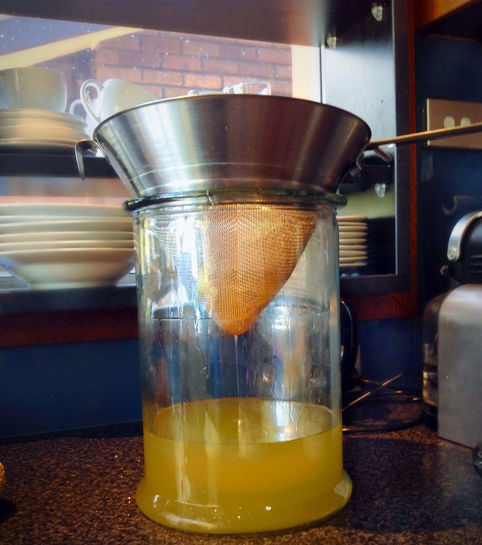 Filtering using large sieve  & unbleached coffee filters. I strain the solid skins out after steeping, using cheese-cloth. I filter before and after ageing using paper unbleached coffee filters.