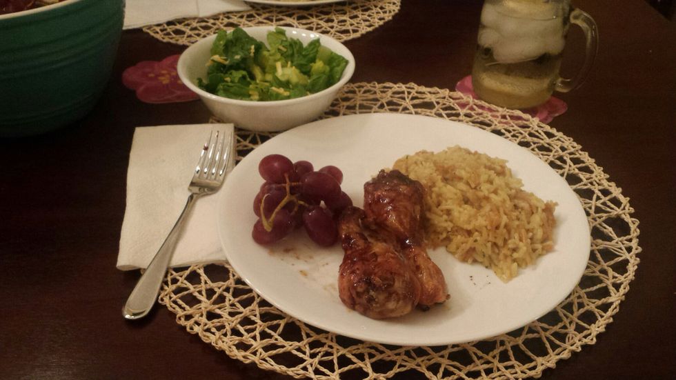 Final meal. 2 Apple-Honey drumsticks, a small portion of rice, some salad with a little dressing, and some grapes.