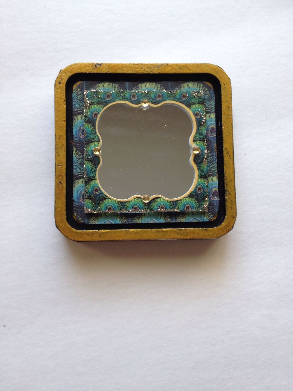 Finally, add some little crystals to your mirror. Set aside the base of your ink pad and locate your lid.