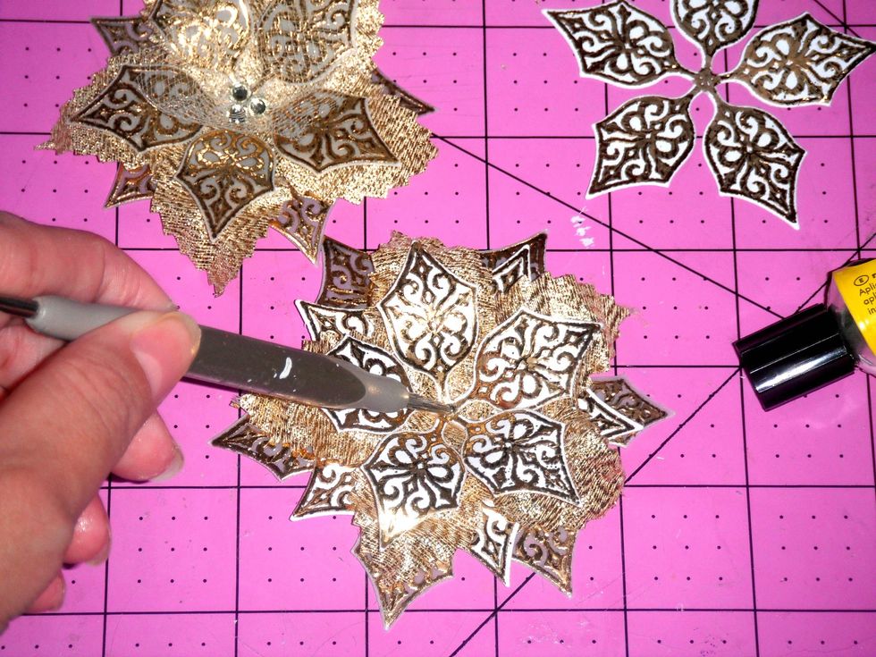 Finally adhere the stamped flowers on top of the ribbon flowers. You can also attach stamped flowers to the back to make the poinsettias larger and fuller.