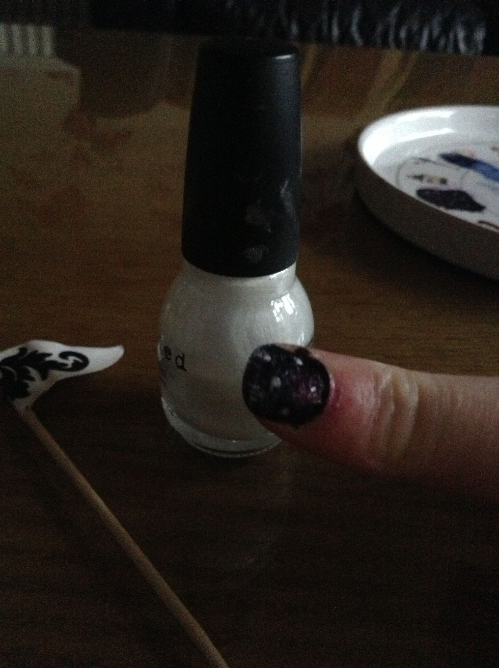 Finally, get the toothpick and dot a few white dots randomly around the nail.