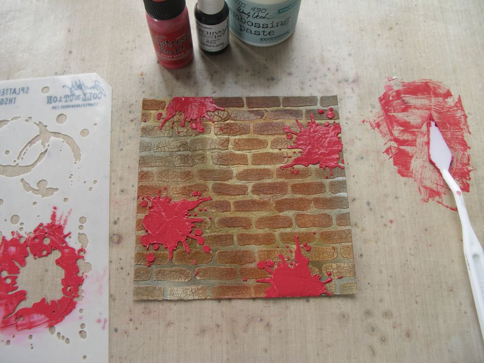 Finally mix translucent embossing paste with Fired Brick Distress Paint and Red Geranium Archival Reinker. Spread it through an 'ink splatter' stencil in various places on the wall background.