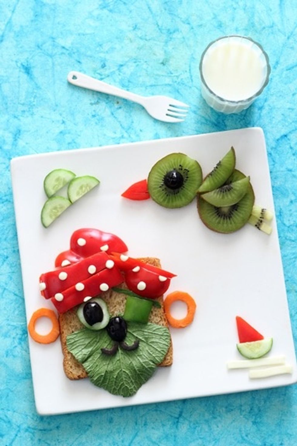 Finally place the cucumber clouds , cucumber and  pepper ship and  cheese waves and let the Pirate fun begin.