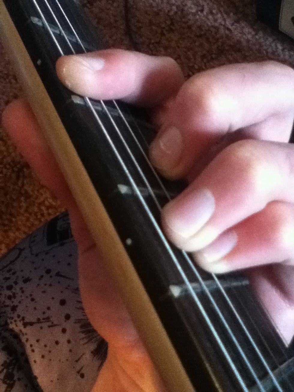 Finally, place your middle finer in between the two parts, on the fourth string down from the top of the bar.