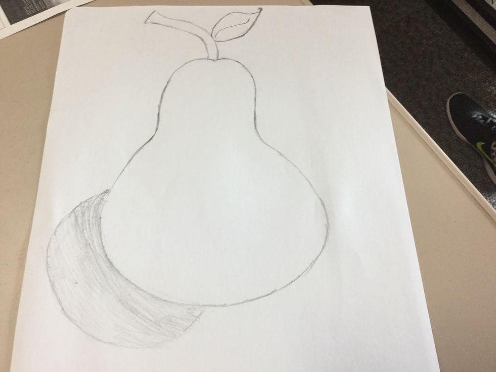 Finally, shade in the semicircle and remember when you draw, press hard when is near the pear and shad lightly when is far away from the pear.