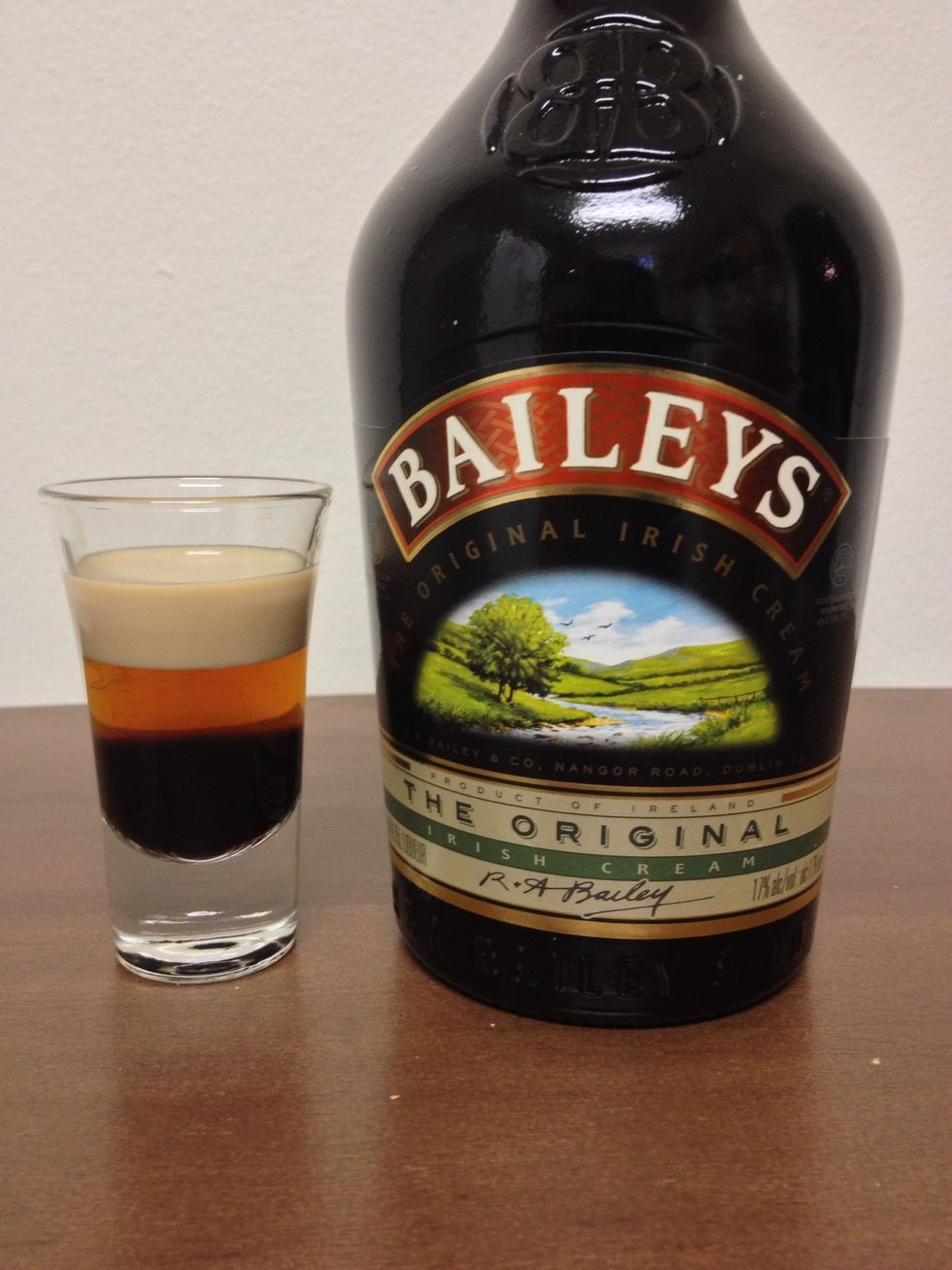 Finally, slow-pour a 1/2oz of Bailey's Irish Cream.
