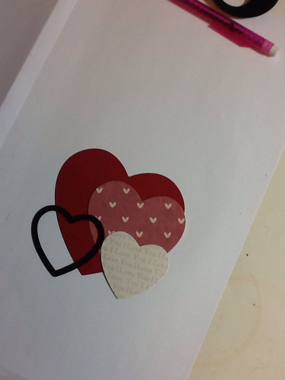 Finally! Take the first patterned paper and cut out an even smaller heart (if your doing this freehand with scissors then you are a better person than me!)