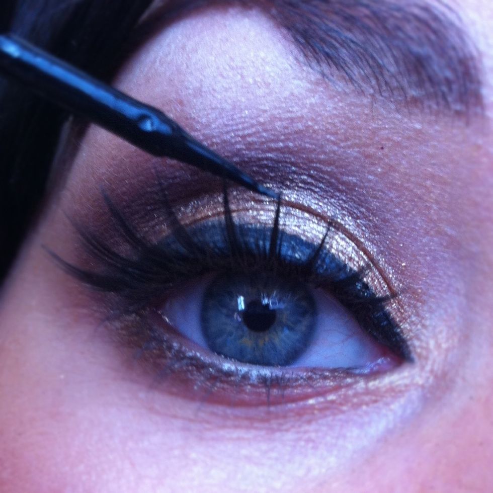 Finally use a liquid eyeliner to create a strong winged eyeliner. Apply this just to your top lash line.