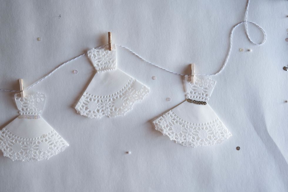 Finally, use tape to hang your completed doily wedding dress garland :)  http://www.brit.co/category/weddings/diy-weddings/