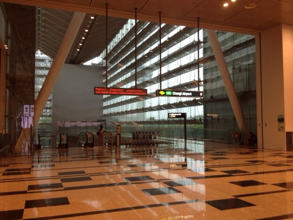 Finally you will see the sign board for Singapore train, which looks like this. The train system in Singapore is often referred to as Mass Rapid Transit (MRT) and can be identified by the yellow icon