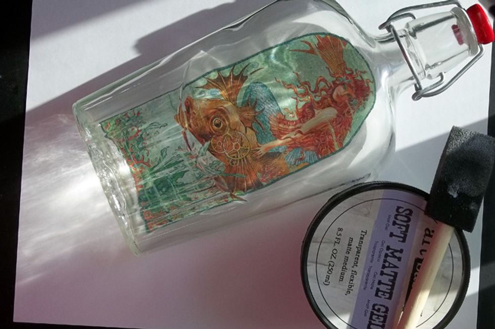 Find a bottle that will fit the image - I'm using an old Maple Syrup bottle with a latch lid. Use Soft Matte Gel Medium & adhere image to the back of the bottle with the mermaid facing forward.