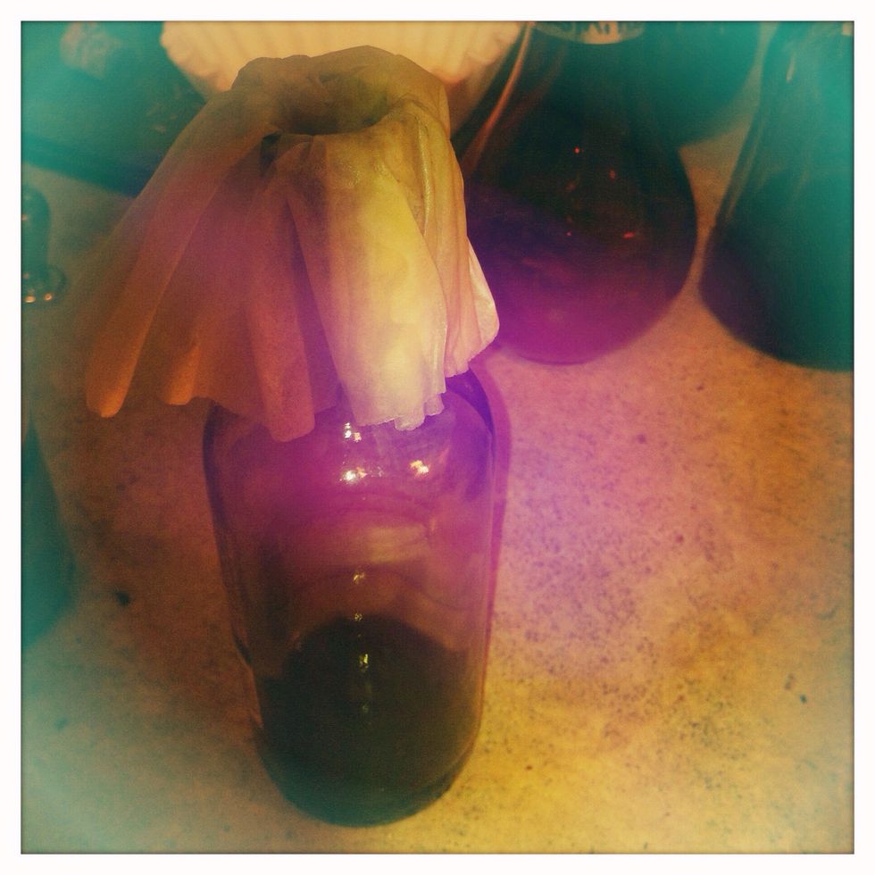 Find a glass bottle to store the tincture long term, preferably green or brown to keep light out, but it can be any color if you store the tincture in a dark cabinet. Secure a coffee filter to the top