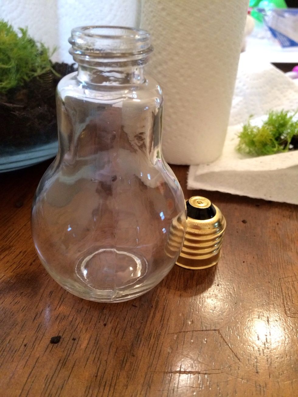 Find a light bulb. I used a fake glass light bulb from Michael's that stands on its own. You can use a real light bulb if you gut it and use a bolt to help it stand. Be careful not to get cut!