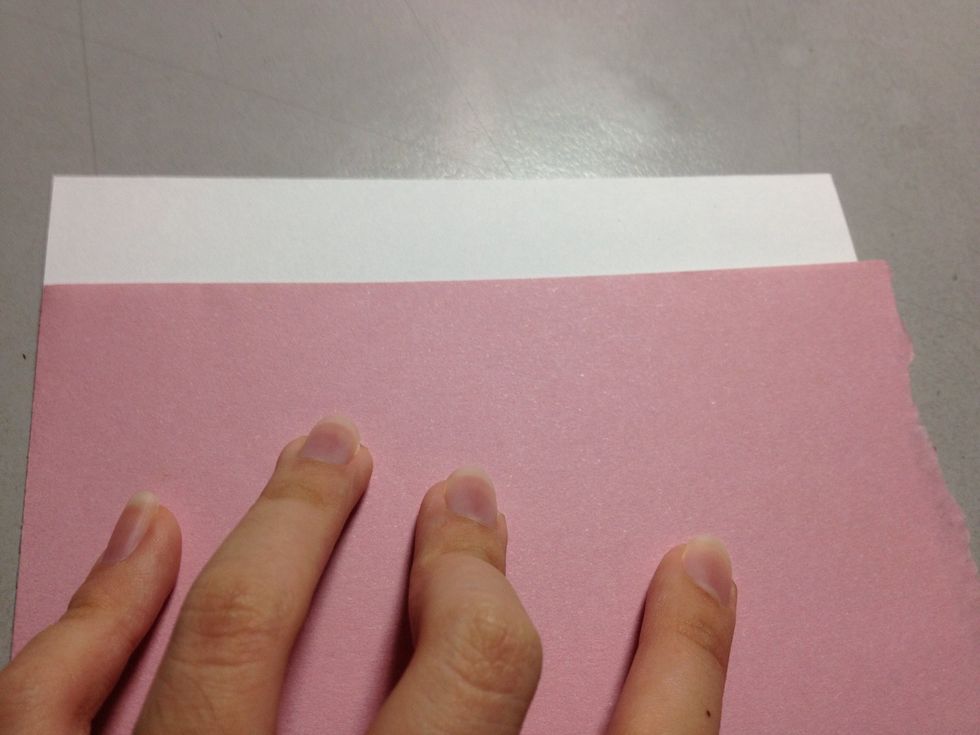 Find a piece of coloured paper which stretches over the entire length of the card.