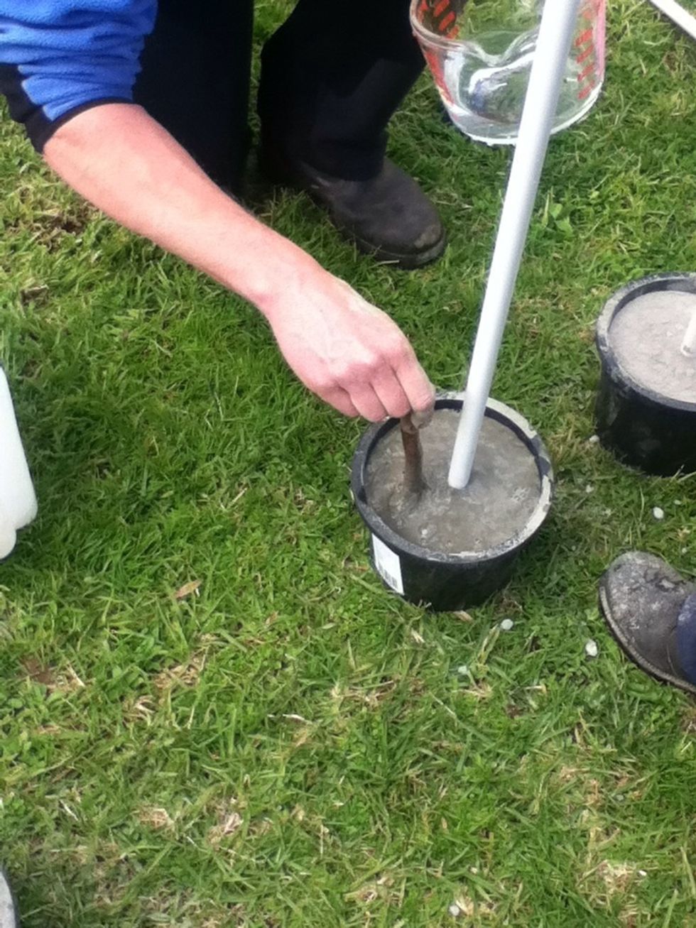 Find a stick and mix the cement and water together so there is no dry or powdery cement left over.