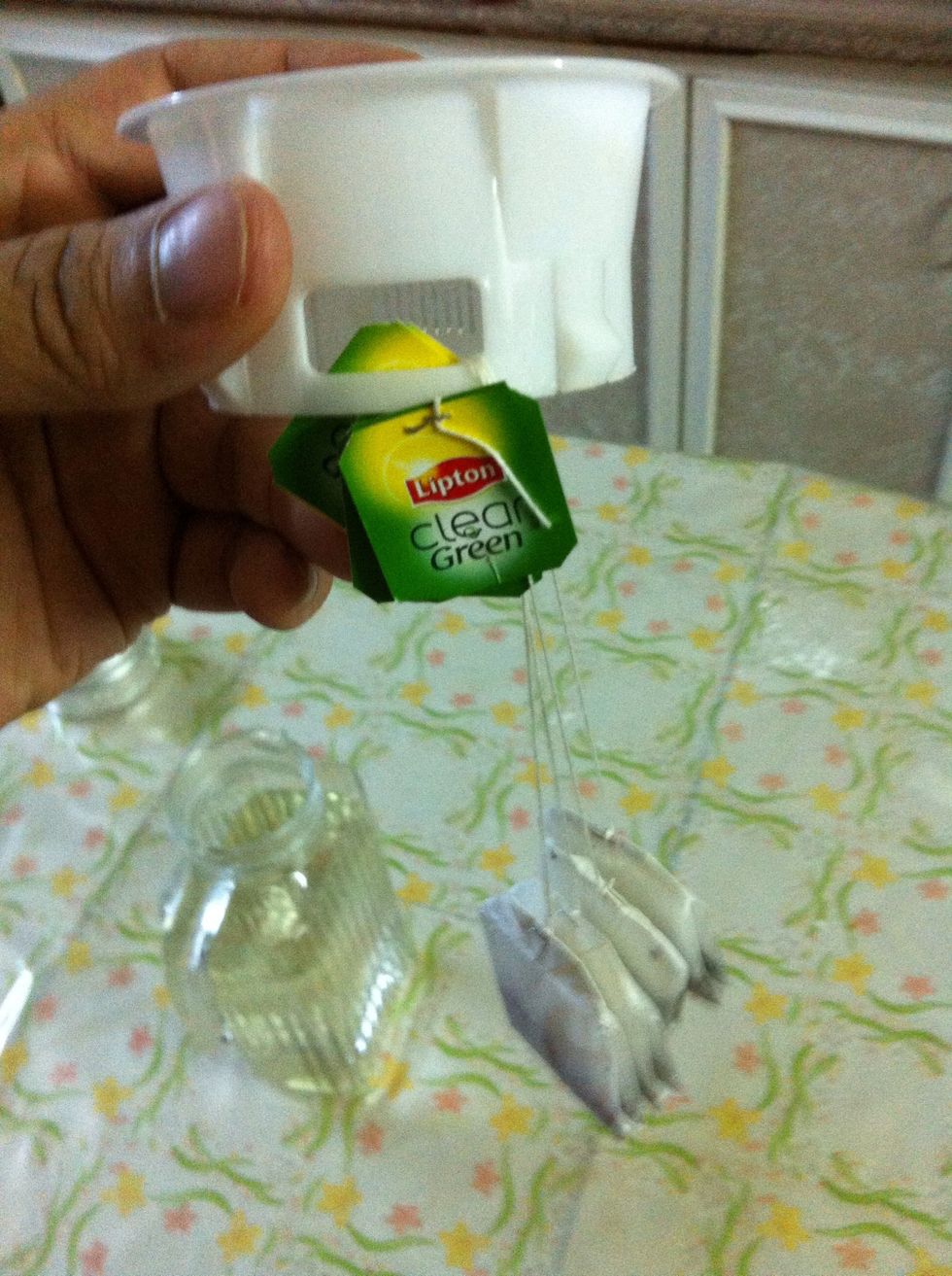 Find a way to attach the tea bags to the lid of the pitcher. This is for easy removal later. Don't stress this step too much, you can just throw the tea bags right into the pitcher.