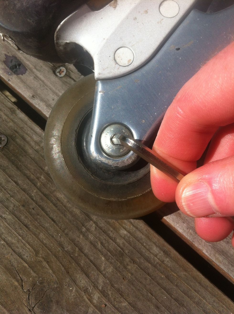 Find an allen wrench that fits and unscrew the axel.
