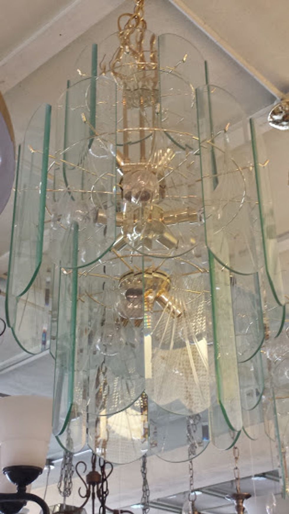 Find an old chandelier, something like this one. Remove all old hanging pieces. Make sure all sockets have bulbs in them. Spray paint, I chose black, I like using Krylon color master.