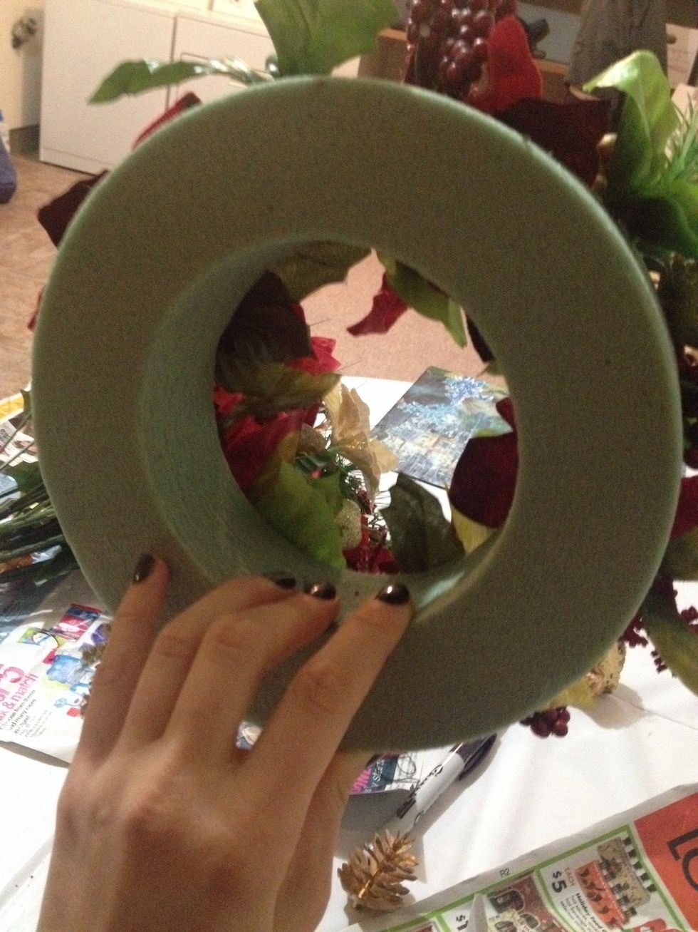 Find circular foam (with a cut-out center for a candle). Pull plant parts off wire stem. Place foliage in desired location, push into foam. Remove, squeeze hot glue in hole, replace plant. Repeat!