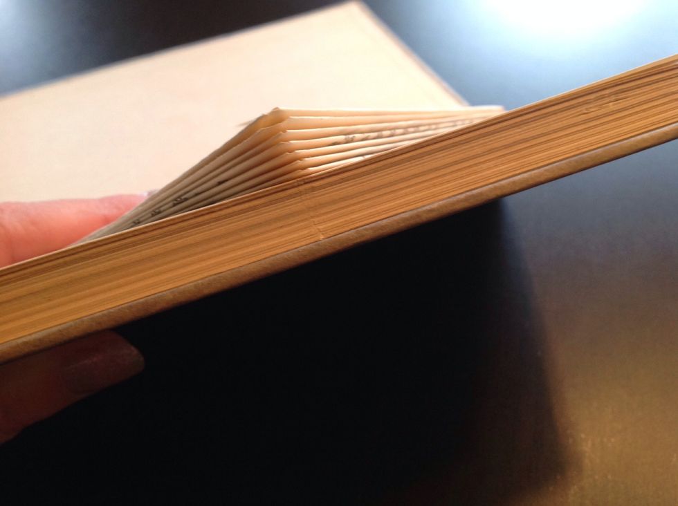 Find out where the middle of the book is and use a sharp tool to mark it, for example a knife or scissors.