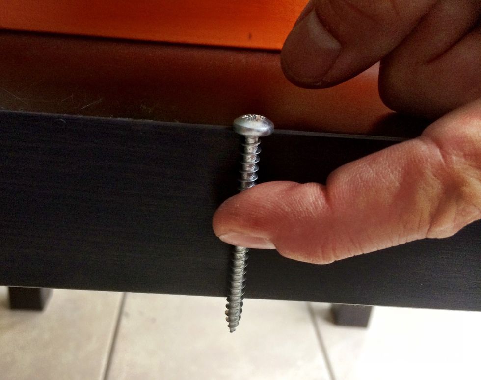 Find screws that are long enough but don't protrude through the bottom of the Lack IKEA table. Take into account the depth of the cube too.