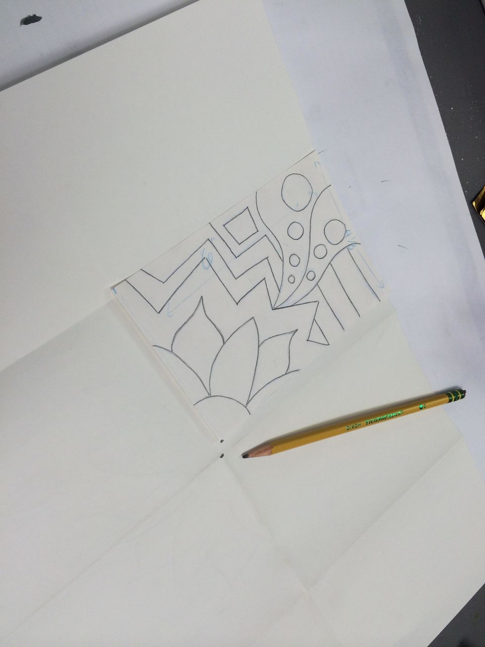 Find the central intersection on your large paper and fit the designed paper in a section so the corner where you began drawing lines up to the intersection.
