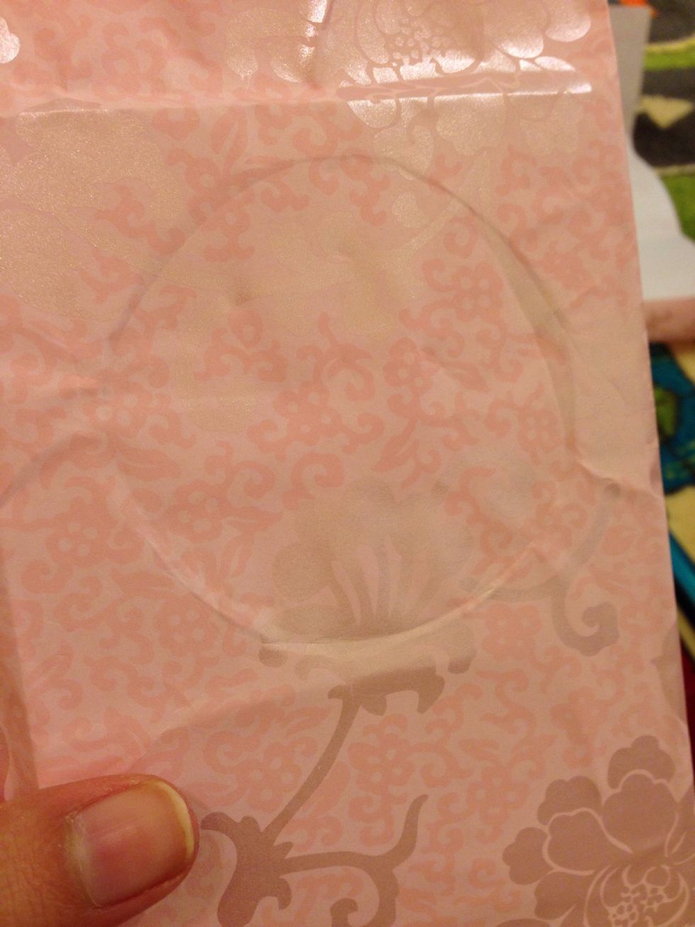 find the circle Using your nail, mark it and cut it with cutter. But cut the circle on one side, leave the other circle on the other side.