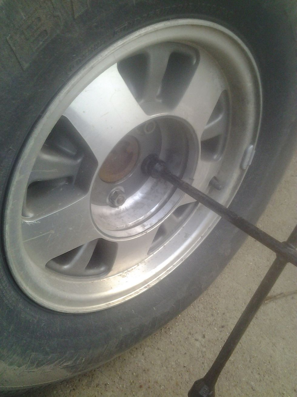 Find the right size end on your 4-way that fits your lug nuts. Break them loose, but don't take them all the way off just yet.