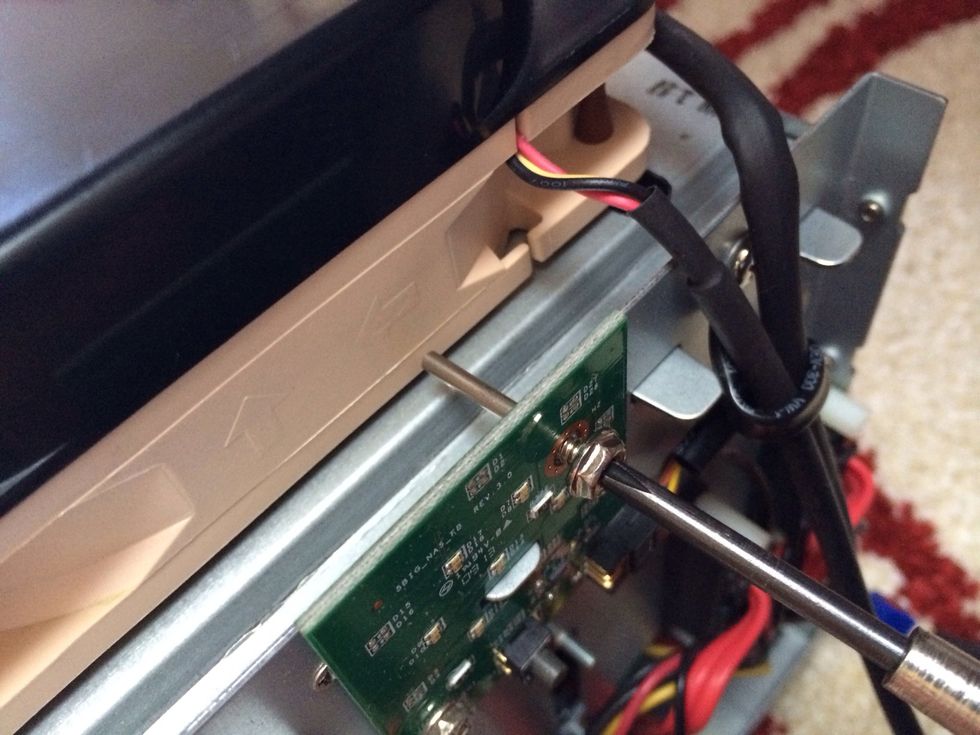 Find the screw that holds the fan and take it out