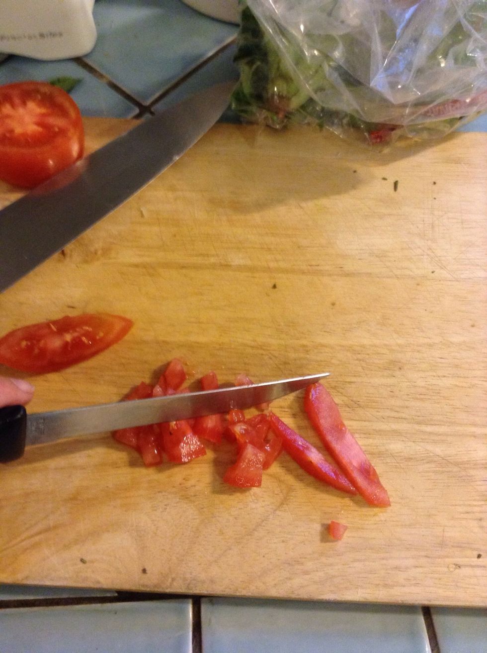 Finely chop some tomato - about 1/3 of a tomato per serving.
