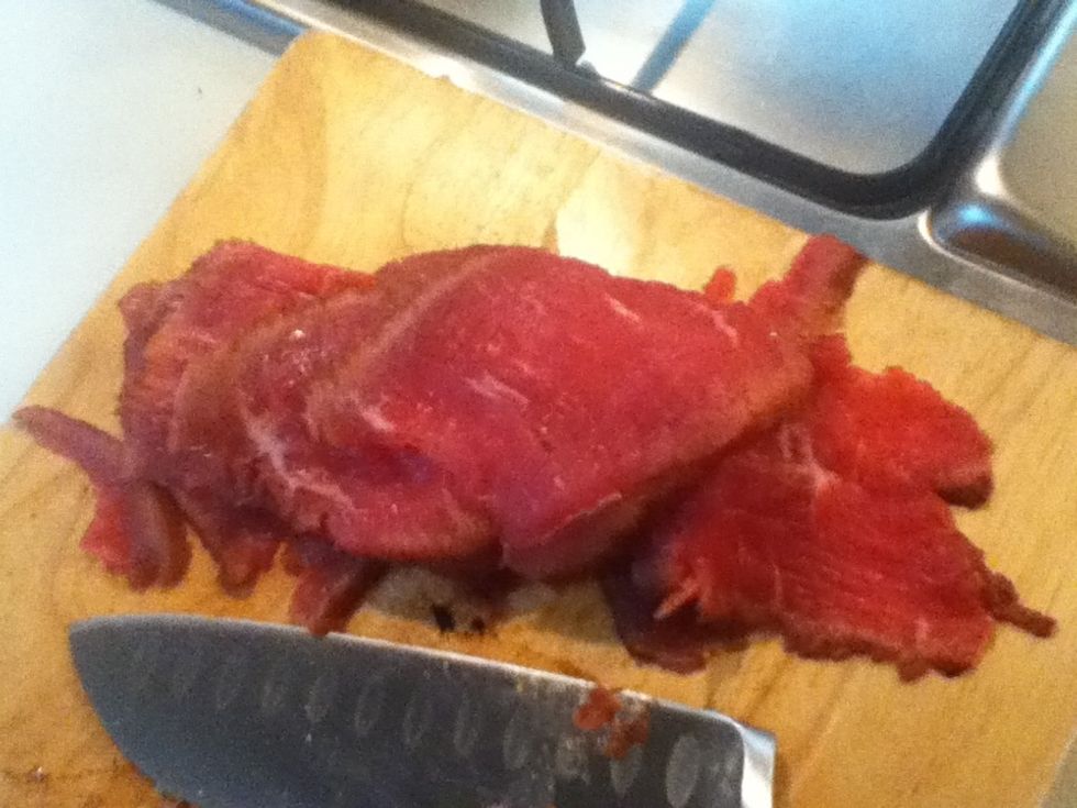 Finely cut the beef into slice ... Sorry if my cutting skills are not that good. You Can't really see from the picture but the middle should be rare while the sides should be brownish cooked