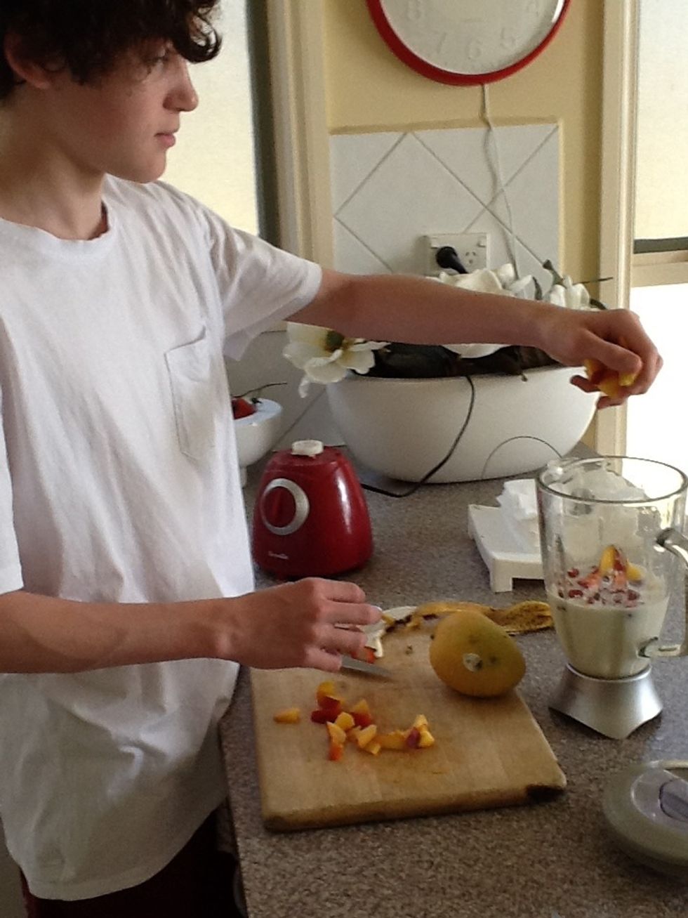 Finely cut up the peach and put it in the blender.
