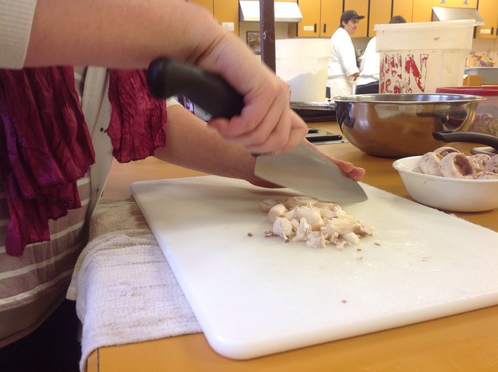 Finely mince the stems, using the proper techniques.